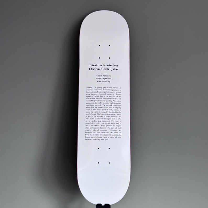 The Whitepaper — skateboard deck printed with the original Bitcoin whitepaper abstract